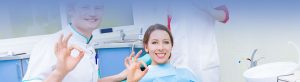 Cropped image of dentist, patient and assisting showing hand gesture 