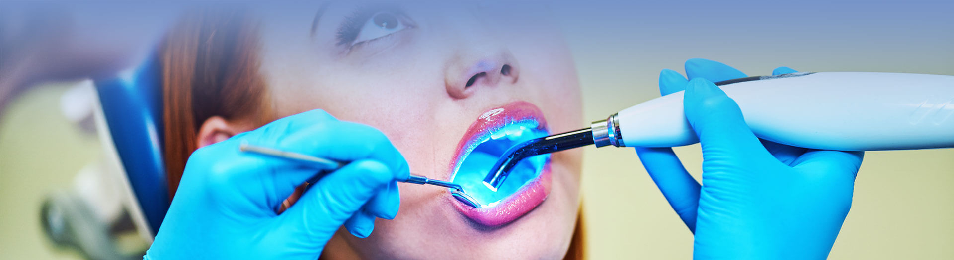 Dentist working with dental polymerization lamp in oral cavity